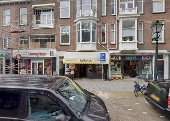 Street scene with cars, buildings, and a cyclist in an urban setting
